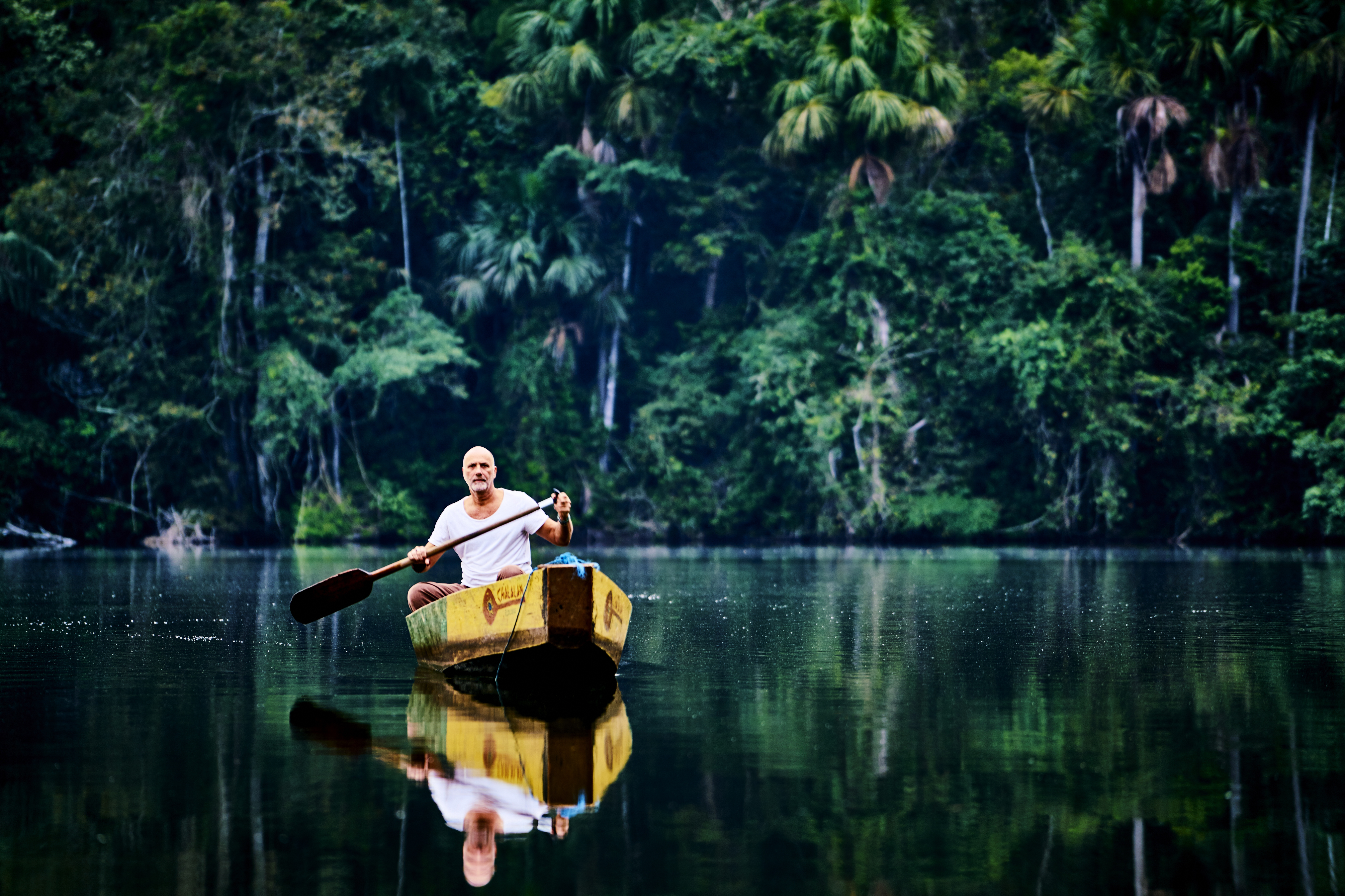 Yossi Ghinsberg paddling on Lake Chalalan, Bolivian Amazon